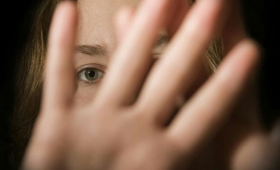 Girl covering the camera with her hands