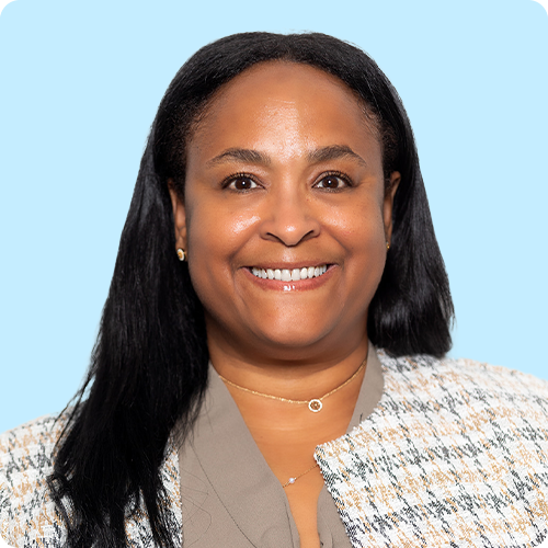 African American professional woman facing the camera, with a warm, welcoming smile.